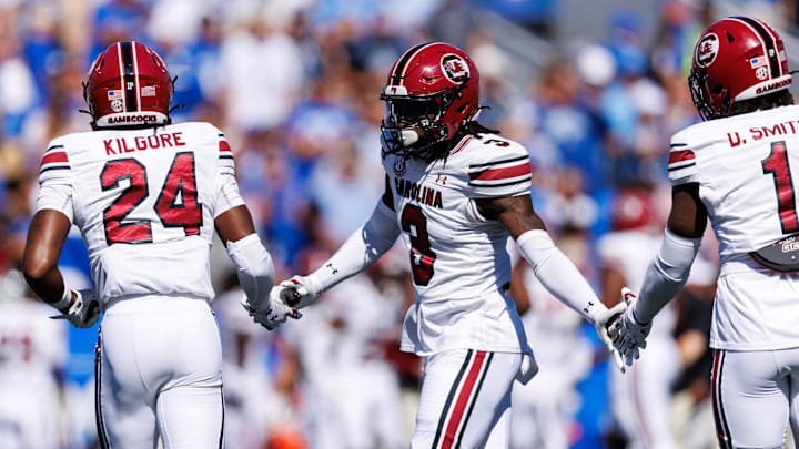 Sep 7, 2024; Lexington, Kentucky, USA; South Carolina Gamecocks defensive back O'Donnell Fortune (3) fives defensive back Jalon Kilgore (24) and defensive back DQ Smith (1) during the first quarter against the Kentucky Wildcats at Kroger Field. Mandatory Credit: Jordan Prather-Imagn Images