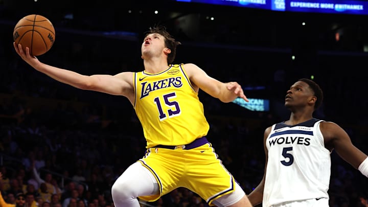 Oct 22, 2024; Los Angeles, California, USA; Los Angeles Lakers guard Austin Reaves (15) shoots against Minnesota Timberwolves guard Anthony Edwards (5) during the second quarter at Crypto.com Arena. Mandatory Credit: Jason Parkhurst-Imagn Images