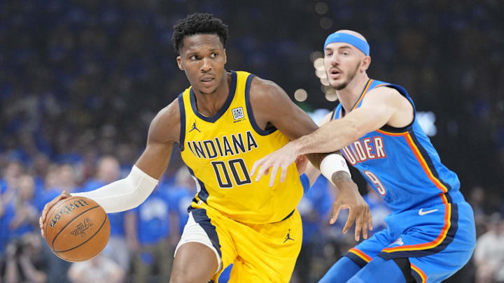 Jun 22, 2025; Oklahoma City, Oklahoma, USA; Indiana Pacers guard Bennedict Mathurin (00) dribbles the ball against Oklahoma City Thunder guard Alex Caruso (9) during the first half of game seven of the 2025 NBA Finals at Paycom Center. Mandatory Credit: Kyle Terada-Imagn Images Jun 22, 2025; Oklahoma City, Oklahoma, USA; Indiana Pacers guard Bennedict Mathurin (00) dribbles the ball against Oklahoma City Thunder guard Alex Caruso (9) during the first half of game seven of the 2025 NBA Finals at Paycom Center. Mandatory Credit: Kyle Terada-Imagn Images