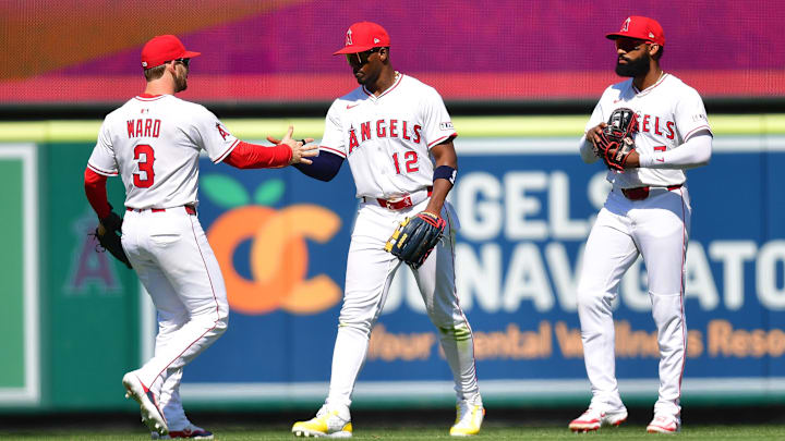 Angels left fielder Taylor Ward (3) right fielder Jorge Soler (12) and center fielder Jo Adell (7) celebrate the victory against the Athletics at Angel Stadium on June 11.