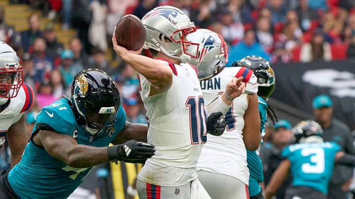 Oct 20, 2024; London, United Kingdom; New England Patriots quarterback Drake Maye (10) throws the ball under pressure from Jacksonville Jaguars defensive end Josh Hines-Allen (41) in the first half during an NFL International Series game at Wembley Stadium. Mandatory Credit: Peter van den Berg-Imagn Images Oct 20, 2024; London, United Kingdom; New England Patriots quarterback Drake Maye (10) throws the ball under pressure from Jacksonville Jaguars defensive end Josh Hines-Allen (41) in the first half during an NFL International Series game at Wembley Stadium. Mandatory Credit: Peter van den Berg-Imagn Images