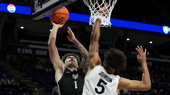 Nov 20, 2024; University Park, Pennsylvania, USA; Purdue Fort Wayne Mastodons guard Jalen Jackson (1) shoots the ball as Penn State Nittany Lions guard/forward Puff Johnson (5) defends during the second half at Bryce Jordan Center. Penn State defeated Purdue Fort Wayne 102-89. Mandatory Credit: Matthew O'Haren-Imagn Images