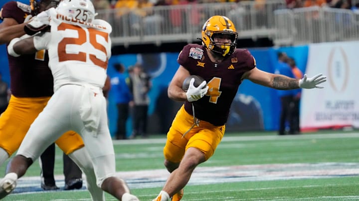 Arizona State running back Cam Skattebo (4) runs against Texas defensive back Jelani McDonald (25) during the third quarter of the Chick-fil-A Peach Bowl in Atlanta on Wednesday, Jan. 1, 2025.