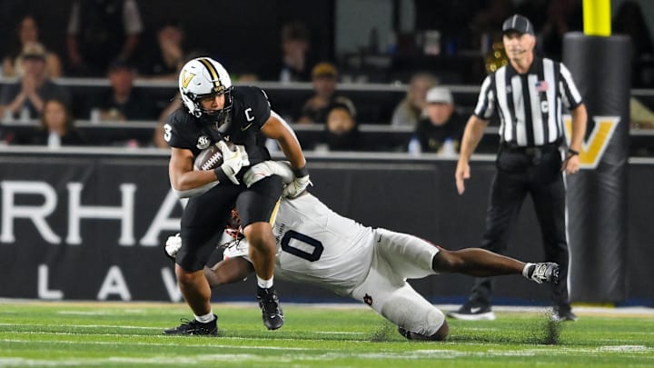 Nov 8, 2025; Nashville, Tennessee, USA;  Vanderbilt Commodores tight end Eli Stowers (9) breaks the tackle of Auburn Tigers linebacker Robert Woodyard Jr. (0) during the second half at FirstBank Stadium. Mandatory Credit: Steve Roberts-Imagn Images