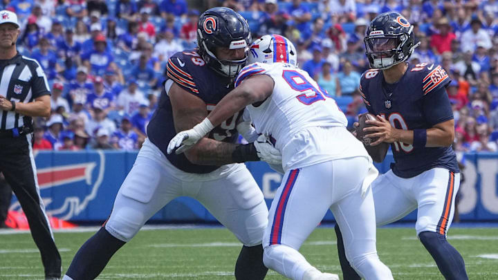 Matt Pryor blocks  Buffalo Bills defensive end Dawuane Smoot as Caleb Williams looks downfield for a target in the second Bears preseason game.