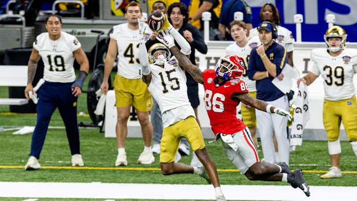 Jan 2, 2025; New Orleans, LA, USA; Georgia Bulldogs wide receiver Dillon Bell (86) blocks a pass almost intercepted by Notre Dame Fighting Irish cornerback Leonard Moore (15) during the second half at Caesars Superdome. Mandatory Credit: Stephen Lew-Imagn Images Jan 2, 2025; New Orleans, LA, USA; Georgia Bulldogs wide receiver Dillon Bell (86) blocks a pass almost intercepted by Notre Dame Fighting Irish cornerback Leonard Moore (15) during the second half at Caesars Superdome. Mandatory Credit: Stephen Lew-Imagn Images