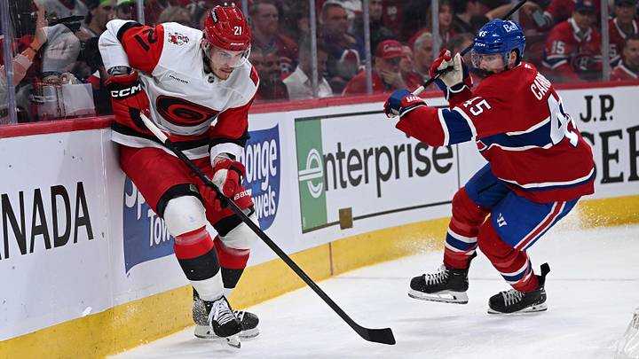 May 27, 2026; Montreal, Quebec, CAN; Carolina Hurricanes defenseman Alexander Nikishin (21) skates past Montreal Canadiens defenseman Alexandre Carrier (45) during the second period in game four of the Eastern Conference Final of the 2026 Stanley Cup Playoffs at Bell Centre. Mandatory Credit: David Kirouac-Imagn Images