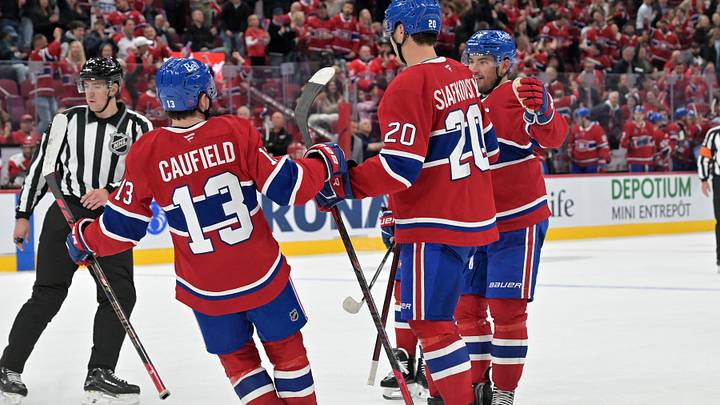 Oct 6, 2026; Montreal, Quebec, CAN;  Montreal Canadiens forward Juraj Slafkovsky (20) celebrates with teammates  forward Cole Caufield (13) and forward Nick Suzuki (14) after scoring a goal against the Carolina Hurricanes  during the third period at the Bell Centre.  Mandatory Credit: Eric Bolte-Imagn Images