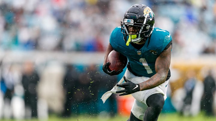 Dec 29, 2024; Jacksonville, Florida, USA; Jacksonville Jaguars running back Travis Etienne Jr. (1) runs the ball against the Tennessee Titans during the second quarter at EverBank Stadium. Mandatory Credit: Morgan Tencza-Imagn Images