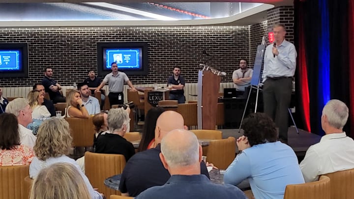 Texas Rangers public relations executive John Blake speaks at a pregame ceremony paying tribute to his 46 years in MLB, including 36 with the Rangers. Blake is retiring from full-time duties at the end of the season.