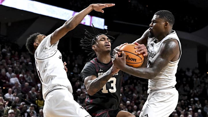 Oklahoma Sooners forward Tae Davis (13) and Texas A&M Aggies forward Rashaun Agee (12) fight for the jump ball during the second half at Reed Arena.
