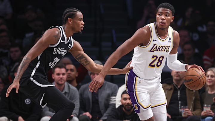 Mar 31, 2024; Brooklyn, New York, USA; Los Angeles Lakers forward Rui Hachimura (28) dribbles against Brooklyn Nets center Nic Claxton (33) during the first half at Barclays Center. Mandatory Credit: Vincent Carchietta-Imagn Images