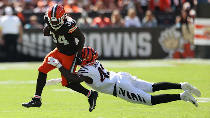 Sep 7, 2025; Cleveland, Ohio, USA; Cleveland Browns running back Jerome Ford (34) is tackled by Cincinnati Bengals linebacker Oren Burks (42) during the second half at Huntington Bank Field.