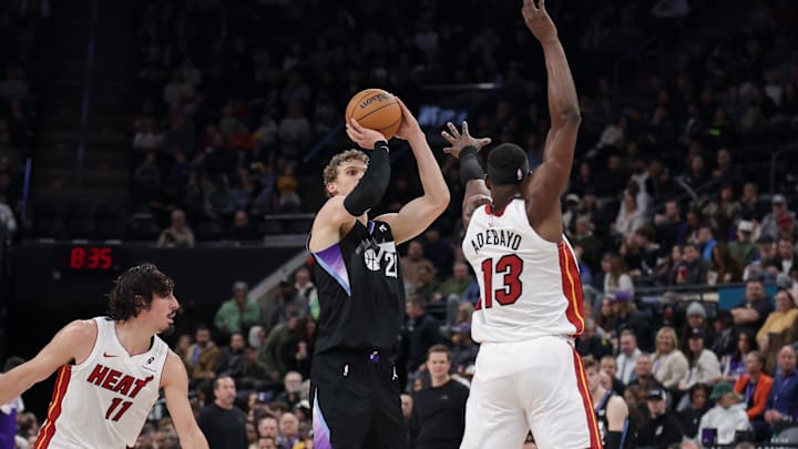 Jan 9, 2025; Salt Lake City, Utah, USA;  Utah Jazz forward Lauri Markkanen (23) shoots a three-point shot past the arm of Miami Heat center Bam Adebayo (13) during the second half at Delta Center. Mandatory Credit: Chris Nicoll-Imagn Images
