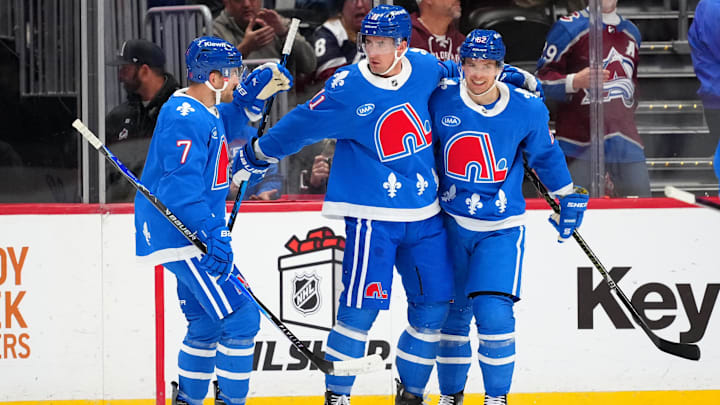 Nov 29, 2025; Denver, Colorado, USA; Colorado Avalanche center Brock Nelson (11) celebrates his first goal with defenseman Devon Toews (7) and left wing Artturi Lehkonen (62) in the first period against the Montreal Canadiens at Ball Arena. Mandatory Credit: Ron Chenoy-Imagn Images
