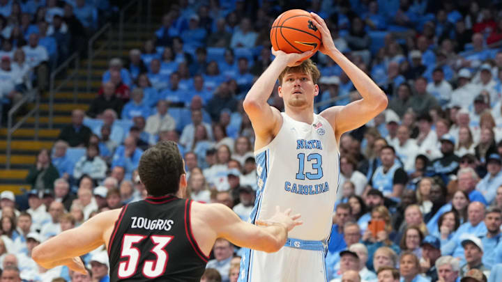 Feb 23, 2026; Chapel Hill, North Carolina, USA; North Carolina Tar Heels center Henri Veesaar (13) shoots a three point shot as Louisville Cardinals forward Vangelis Zougris (53) defends in the second half at Dean E. Smith Center. Mandatory Credit: Bob Donnan-Imagn Images