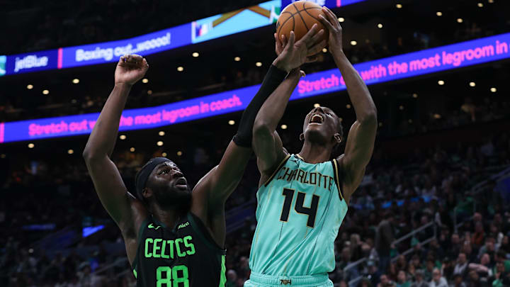 Apr 13, 2025; Boston, Massachusetts, USA; Boston Celtics center Neemias Queta (88) fouls Charlotte Hornets forward Moussa Diabate (14) during the second half at TD Garden. Mandatory Credit: Paul Rutherford-Imagn Images