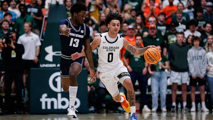 Mar 1, 2025; Fort Collins, Colorado, USA; Colorado State Rams guard Kyan Evans (0) dribbles the ball up court under pressure from Utah State Aggies guard Deyton Albury (13) in the first half at Moby Arena. Mandatory Credit: Isaiah J. Downing-Imagn Images Mar 1, 2025; Fort Collins, Colorado, USA; Colorado State Rams guard Kyan Evans (0) dribbles the ball up court under pressure from Utah State Aggies guard Deyton Albury (13) in the first half at Moby Arena. Mandatory Credit: Isaiah J. Downing-Imagn Images