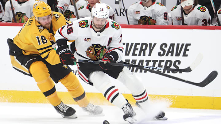 Jan 29, 2026; Pittsburgh, Pennsylvania, USA;  Pittsburgh Penguins right wing Justin Brazeau (left) and Chicago Blackhawks center Jason Dickinson (right) chase the puck during the first period at PPG Paints Arena. Mandatory Credit: Charles LeClaire-Imagn Images