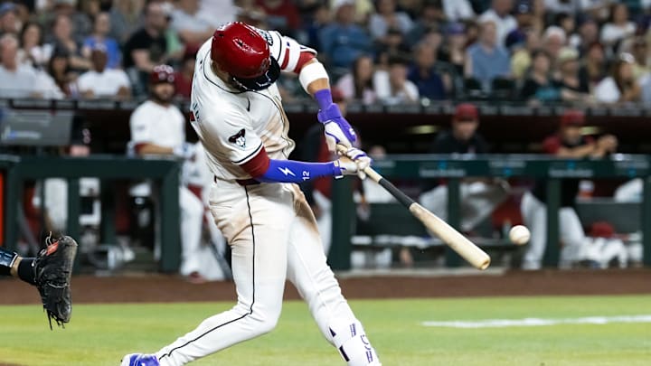 May 27, 2025; Phoenix, Arizona, USA; Arizona Diamondbacks batter Geraldo Perdomo hits a two run single in the fourth inning against the Pittsburgh Pirates at Chase Field. Mandatory Credit: Mark J. Rebilas-Imagn Images
