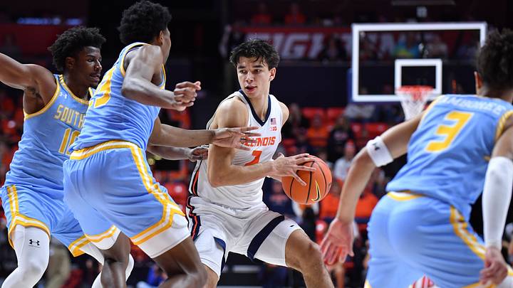 Dec 29, 2025; Champaign, Illinois, USA; Illinois Fighting Illini guard Andrej Stojakovic (2) drives the ball between Southern University Jaguars players during the first half at State Farm Center. Mandatory Credit: Ron Johnson-Imagn Images Dec 29, 2025; Champaign, Illinois, USA; Illinois Fighting Illini guard Andrej Stojakovic (2) drives the ball between Southern University Jaguars players during the first half at State Farm Center. Mandatory Credit: Ron Johnson-Imagn Images