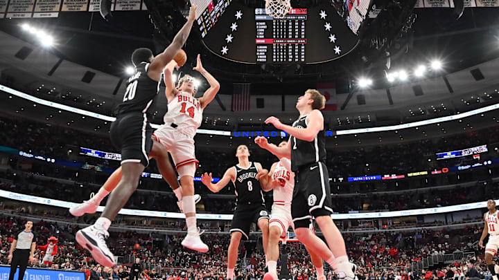 Jan 18, 2026; Chicago, Illinois, USA; Chicago Bulls forward Matas Buzelis (14) shoots against Brooklyn Nets center Day'ron Sharpe (20) during the second half at United Center. Mandatory Credit: Patrick Gorski-Imagn Images