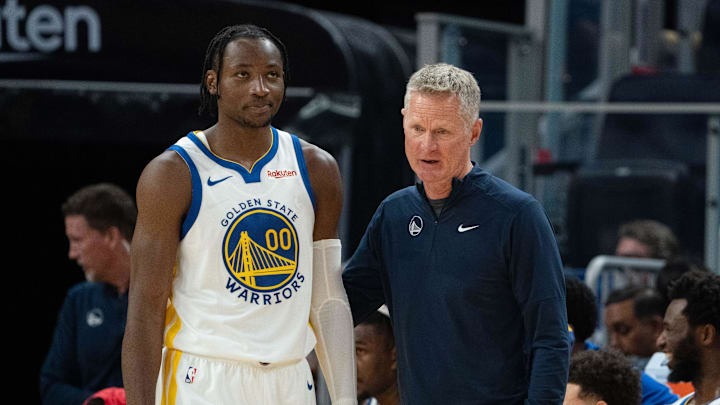 October 20, 2023; San Francisco, California, USA; Golden State Warriors head coach Steve Kerr (right) talks to forward Jonathan Kuminga (00) during the third quarter against the San Antonio Spurs at Chase Center. Mandatory Credit: Kyle Terada-Imagn Images