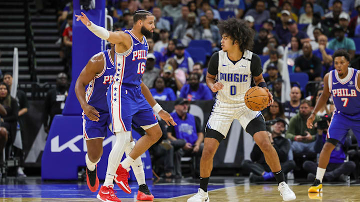 Philadelphia 76ers forward Caleb Martin (16) defends Orlando Magic guard Anthony Black (0) during the second quarter at Kia Center.