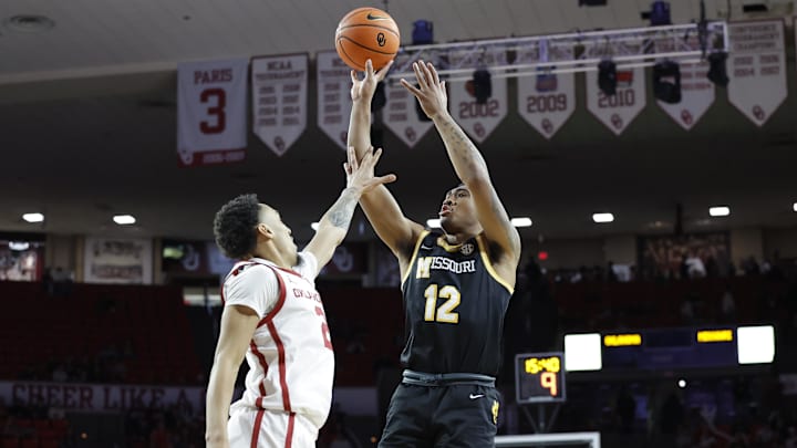 Missouri Tigers guard Tony Perkins (12) attempts a shot over a defender, in a game against the Oklahoma Sooners this season.