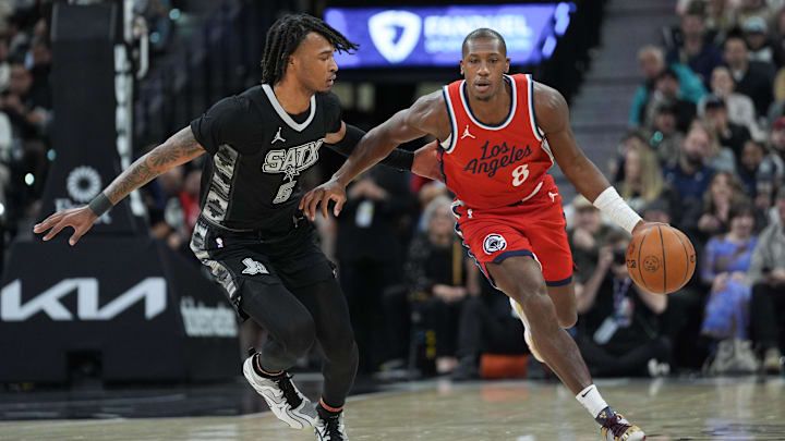 Dec 31, 2024; San Antonio, Texas, USA;  LA Clippers guard Kris Dunn (8) dribbles against San Antonio Spurs guard Stephon Castle (5) in the first half at Frost Bank Center. Mandatory Credit: Daniel Dunn-Imagn Images