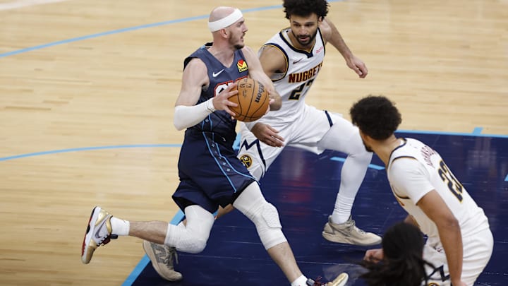 Feb 27, 2026; Oklahoma City, Oklahoma, USA; Oklahoma City Thunder guard Alex Caruso (9) drives to the basket between Denver Nuggets guard Jamal Murray (27) and forward Cameron Johnson (23) during the fourth quarter at Paycom Center.