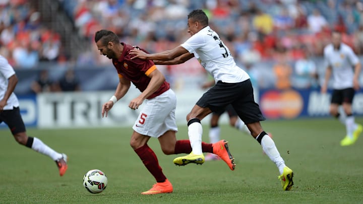 Jul 26, 2014; Denver, CO, USA; Manchester United midfielder Jesse Lingard (35) pushes AS Roma defender Leandro Castan (5) in the second half at Sports Authority Field. Manchester United defeated AS Roma 3-2. Mandatory Credit: Ron Chenoy-Imagn Images