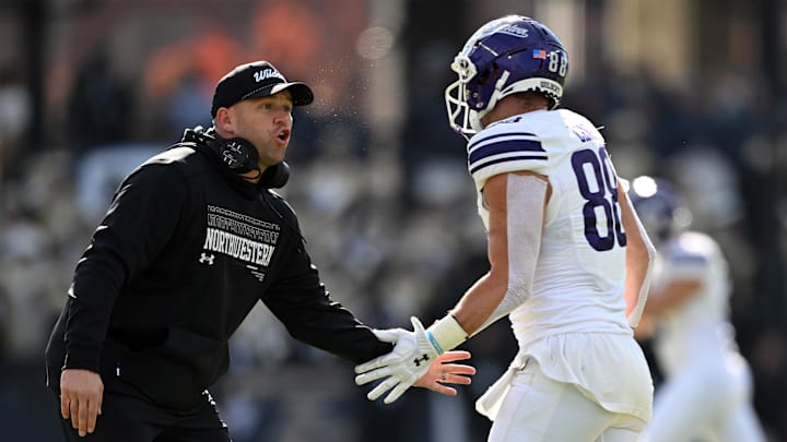 Nov 2, 2024; West Lafayette, Indiana, USA; Northwestern Wildcats head coach David Braun high fives Northwestern Wildcats tight end Marshall Lang (88) during the second quarter at Ross-Ade Stadium. Mandatory Credit: Marc Lebryk-Imagn Images