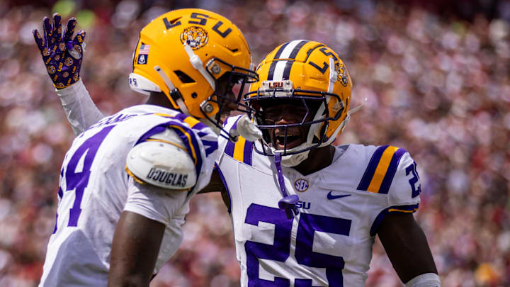 Sep 14, 2024; Columbia, South Carolina, USA; LSU Tigers cornerback Javien Toviano (25) celebrates with cornerback Zy Alexander (14) after an interception against the South Carolina Gamecocks in the first quarter at Williams-Brice Stadium. Mandatory Credit: Scott Kinser-Imagn Images