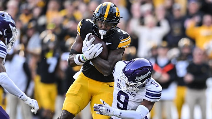 Oct 26, 2024; Iowa City, Iowa, USA; Iowa Hawkeyes running back Kaleb Johnson (2) runs for a 26 yard touchdown against Northwestern Wildcats defensive back Braden Turner (9) during the second quarter at Kinnick Stadium. Mandatory Credit: Jeffrey Becker-Imagn Images Oct 26, 2024; Iowa City, Iowa, USA; Iowa Hawkeyes running back Kaleb Johnson (2) runs for a 26 yard touchdown against Northwestern Wildcats defensive back Braden Turner (9) during the second quarter at Kinnick Stadium. Mandatory Credit: Jeffrey Becker-Imagn Images