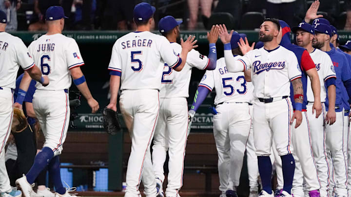 Apr 16, 2025; Arlington, Texas, USA; Texas Rangers shortstop Corey Seager (5) and center fielder Kevin Pillar (1) prepare to high five following a game against the Los Angeles Angels at Globe Life Field. Mandatory Credit: Raymond Carlin III-Imagn Images