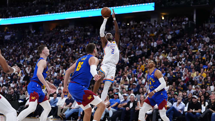 May 9, 2025; Denver, Colorado, USA; Oklahoma City Thunder guard Shai Gilgeous-Alexander shoots the ball as Denver Nuggets guard Christian Braun (0), center Nikola Jokic (15) and guard Russell Westbrook (4) watch in the second quarter during Game 3 of the second round at Ball Arena. Mandatory Credit: Ron Chenoy-Imagn Images May 9, 2025; Denver, Colorado, USA; Oklahoma City Thunder guard Shai Gilgeous-Alexander shoots the ball as Denver Nuggets guard Christian Braun (0), center Nikola Jokic (15) and guard Russell Westbrook (4) watch in the second quarter during Game 3 of the second round at Ball Arena. Mandatory Credit: Ron Chenoy-Imagn Images