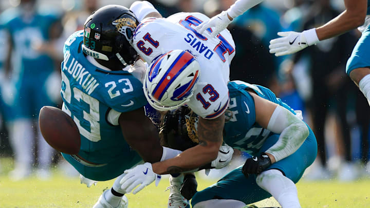 Buffalo Bills wide receiver Gabe Davis (13), center, can’t haul in a reception against Jacksonville Jaguars safety Andrew Wingard (42), bottom, and linebacker Foyesade Oluokun (23), left, during the fourth quarter of an NFL football AFC Wild Card playoff matchup, Sunday, Jan. 11, 2026, in Jacksonville, Fla. Buffalo Bills wide receiver Gabe Davis (13), center, can’t haul in a reception against Jacksonville Jaguars safety Andrew Wingard (42), bottom, and linebacker Foyesade Oluokun (23), left, during the fourth quarter of an NFL football AFC Wild Card playoff matchup, Sunday, Jan. 11, 2026, in Jacksonville, Fla.