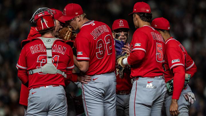 Sep 26, 2026; Seattle, Washington, USA;  Los Angeles Angels, from left, catcher Tyler Heineman (31), interim pitching coach Tim Leveque, starting pitcher Ryan Johnson (32), shortstop Zach Neto (9), first baseman Vaughn Grissom (5) and second baseman Christian Moore (4) meet at the mound during the fifth inning against the Seattle Mariners at T-Mobile Park. Mandatory Credit: Stephen Brashear-Imagn Images