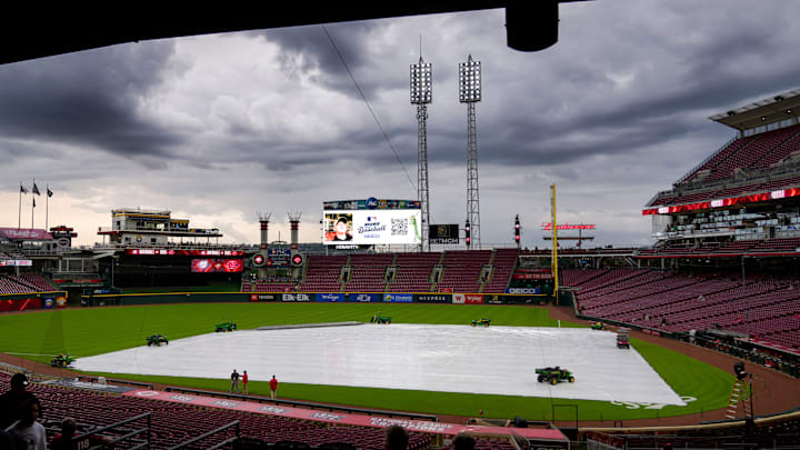 Fans make their ways into the stadium as a rain delay is announced before the first inning of the MLB National League game between the Cincinnati Reds and the Washington Nationals at Great American Ball Park in downtown Cincinnati on Friday, May 2, 2025.
