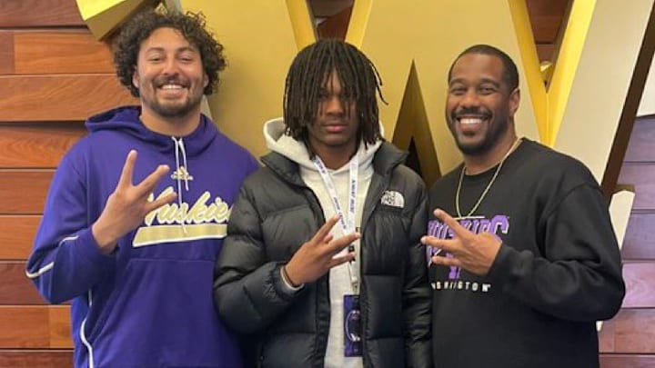 Receiver recruit Cynai Thomas stands with UW coaches Caleb Wilson and Kevin Cummings. Receiver recruit Cynai Thomas stands with UW coaches Caleb Wilson and Kevin Cummings.