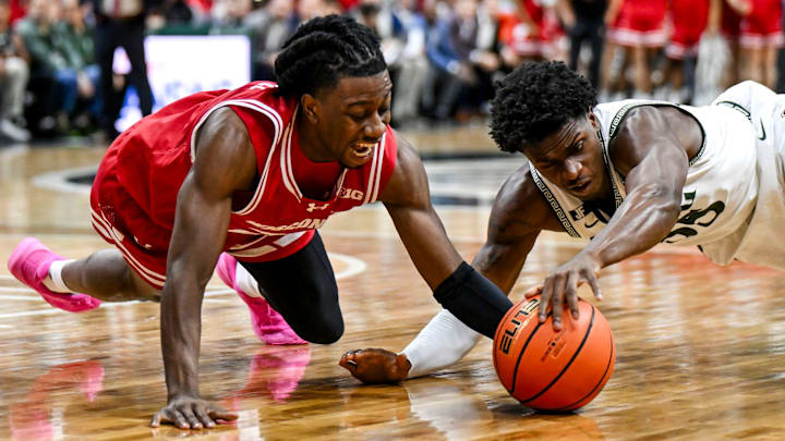 Michigan State's Coen Carr, right, and Wisconsin's John Blackwell go after the ball during the second half on Sunday, March 2, 2025, at the Breslin Center in East Lansing.