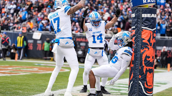 Detroit Lions running back Jahmyr Gibbs (26) celebrates a touchdown against Chicago Bears with wide receiver Amon-Ra St. Brown (14) and wide receiver Tim Patrick (17) during the first half at Soldier Field in Chicago, Ill. on Sunday, Dec. 22, 2024.