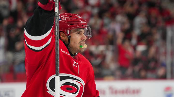 Oct 8, 2026; Raleigh, North Carolina, USA;  Carolina Hurricanes center Logan Stankoven (22) celebrates his hat trick against the Vancouver Canucks during the third period at Lenovo Center.  Mandatory Credit: James Guillory-Imagn Images