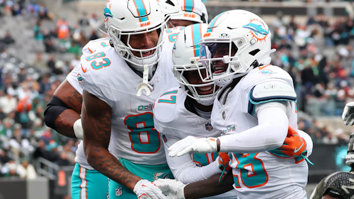 Miami Dolphins running back De'Von Achane (28) celebrates with tight end Darren Waller (83) and wide receiver Jaylen Waddle (17) after scoring a touchdown against the New York Jets during the first half at MetLife Stadium. Miami Dolphins running back De'Von Achane (28) celebrates with tight end Darren Waller (83) and wide receiver Jaylen Waddle (17) after scoring a touchdown against the New York Jets during the first half at MetLife Stadium.