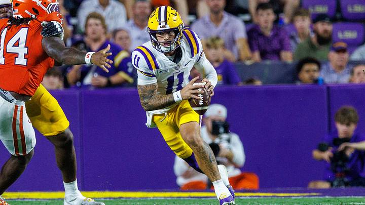 Sep 5, 2026; Baton Rouge, Louisiana, USA; LSU Tigers quarterback Landen Clark (11) scrambles against Clemson Tigers defensive end London Merritt (14) during the second half at Tiger Stadium. Mandatory Credit: Stephen Lew-Imagn Images Sep 5, 2026; Baton Rouge, Louisiana, USA; LSU Tigers quarterback Landen Clark (11) scrambles against Clemson Tigers defensive end London Merritt (14) during the second half at Tiger Stadium. Mandatory Credit: Stephen Lew-Imagn Images