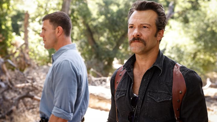 “The Funky Bunch” – Gibbs and Franks investigate the disappearance of a young Marine connected to a mysterious compound with a charismatic leader, and Lala’s fate is revealed, on the second season premiere of NCIS: ORIGINS, Tuesday, Oct. 14 (9:00-10:00 PM, ET/PT) on the CBS Television Network, and streaming on Paramount+ (live and on demand for Paramount+ Premium plan subscribers, or on demand for Paramount+ Essential subscribers the day after the episode airs)*. Pictured (L-R): Austin Stowell
