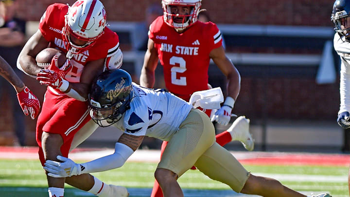 FIU's CJ Christian tackles Jacksonville State's Tre Stewart in their 2024 game.