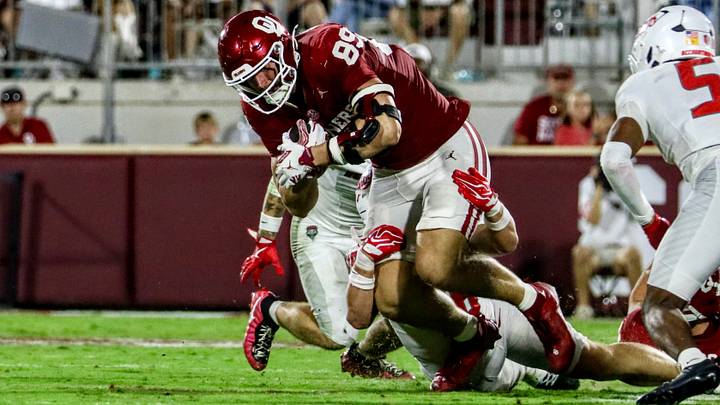 Oklahoma tight end Hayden Hansen tries to break a tackle against New Mexico. Hansen spent the first four season of his collegiate career at Florida before transferring to Oklahoma in the offseason. Oklahoma tight end Hayden Hansen tries to break a tackle against New Mexico. Hansen spent the first four season of his collegiate career at Florida before transferring to Oklahoma in the offseason.