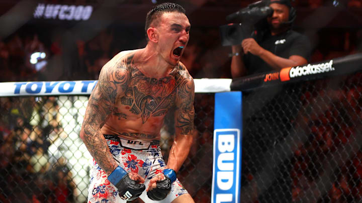 Apr 13, 2024; Las Vegas, Nevada, USA; Max Holloway (blue gloves) reacts after defeating Justin